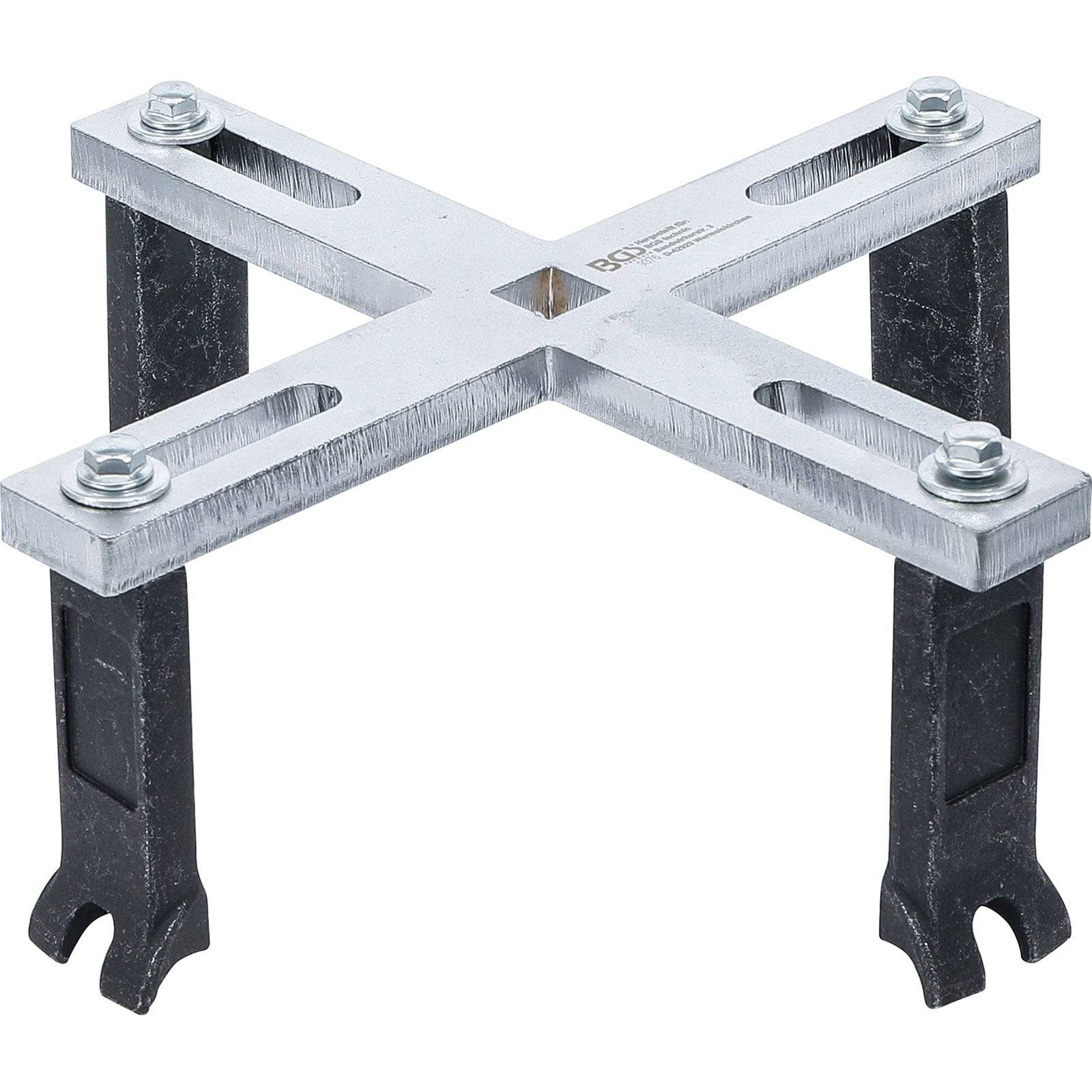Eine silberne Metallhalterung in X-Form mit vier Beinen, die für strukturelle Unterstützung konzipiert ist. An jeder Ecke des Kreuzes sind Bolzen sichtbar.