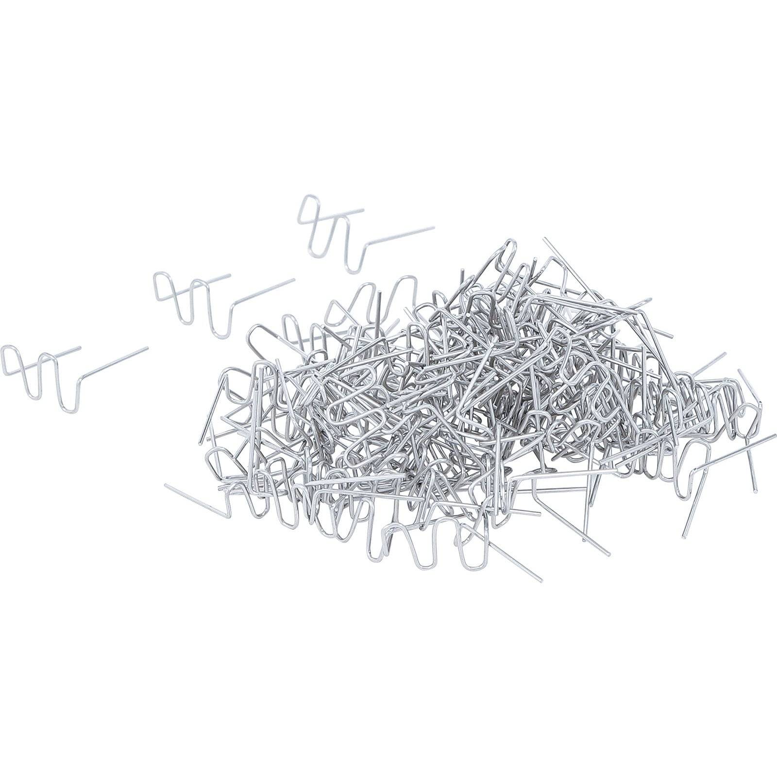 Ein Haufen silberner Hog Rings verstreut, mit einzelnen Ringen sichtbar, die zum Befestigen von Materialien verwendet werden.