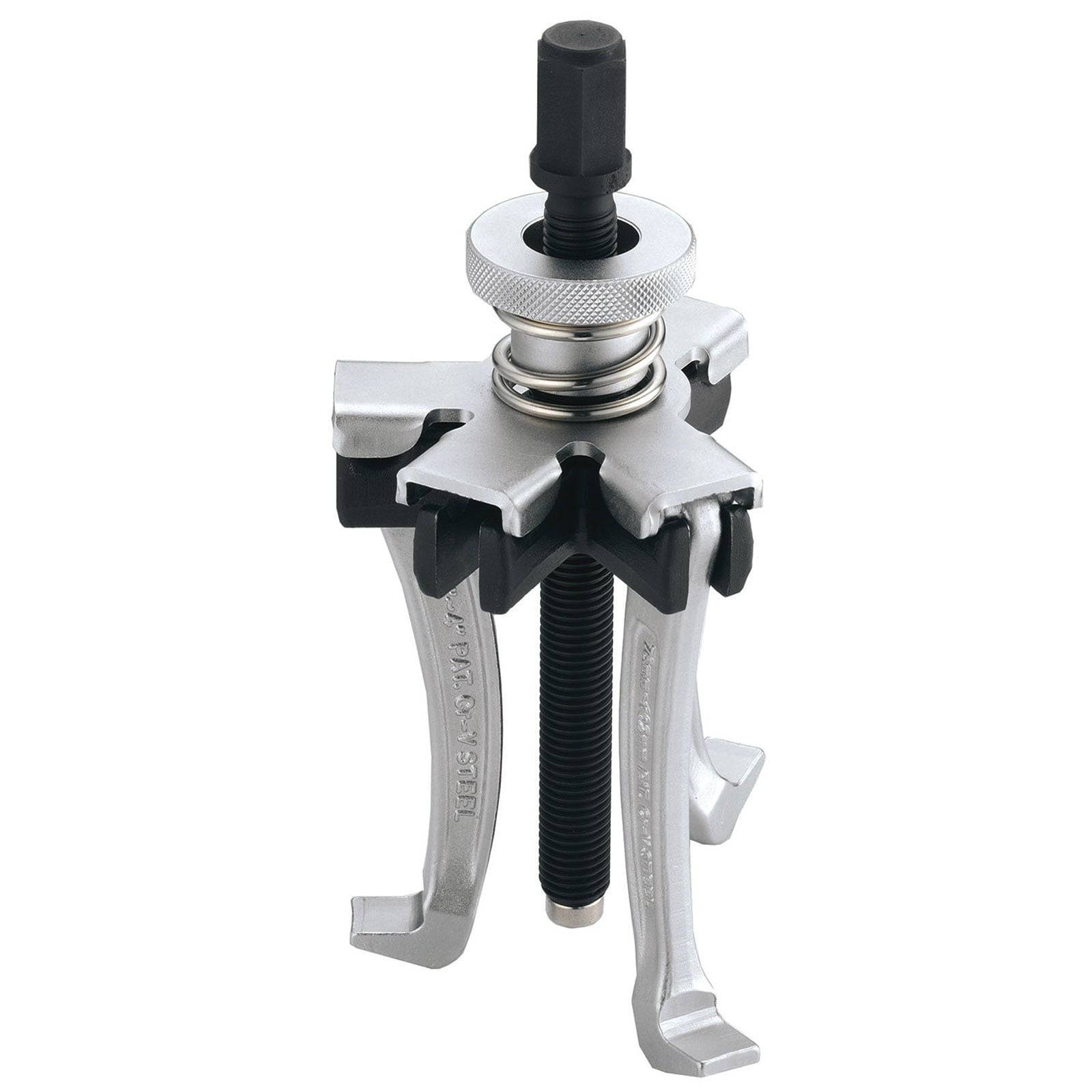 Ein Drei-Backen-Abzieher mit einem schwarzen Schraubenmechanismus und silbernen Armen, der zum Abziehen von Zahnrädern oder Riemenscheiben von Wellen verwendet wird.