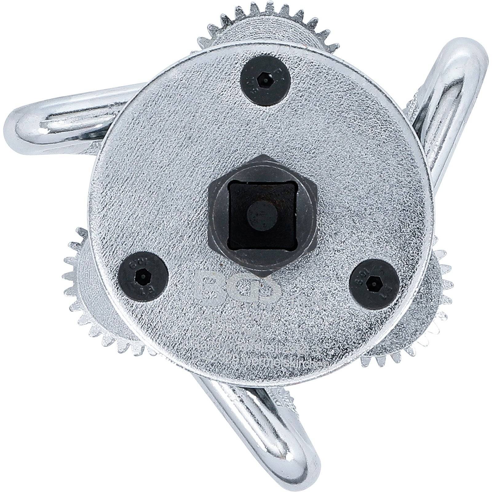 Ein Dreiklauen-Ölfilterschlüssel mit rundem Metallgehäuse und verstellbaren Zahnrädern, entwickelt zum Greifen und Entfernen von Ölfiltern.