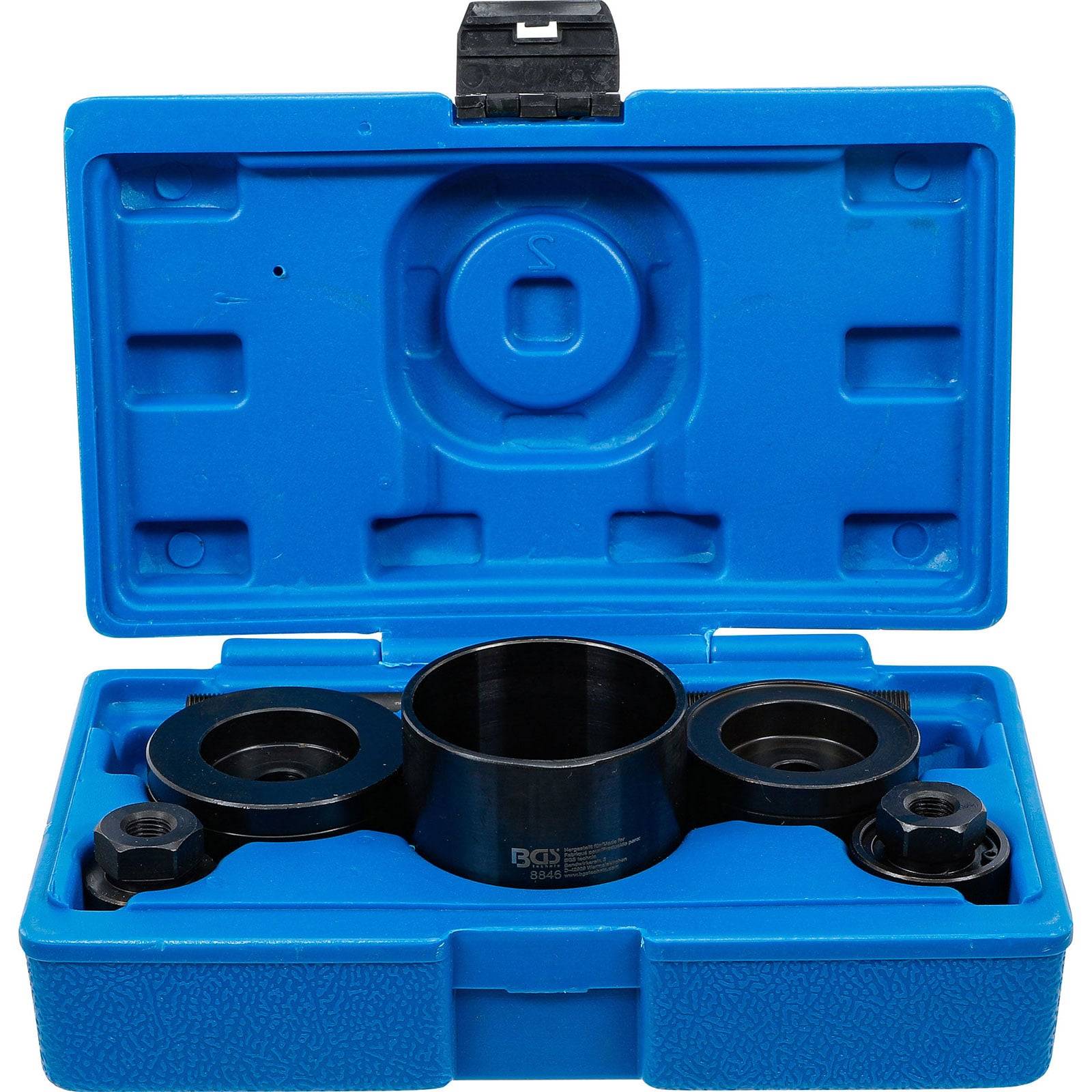 Eine blaue Plastikbox öffnet sich und gibt einen schwarzen Automotivwerkzeug frei, der zum Handhaben von Zahnriemen verwendet wird. Die Box ist so geformt, dass der Werkzeug sicher darin befestigt ist.