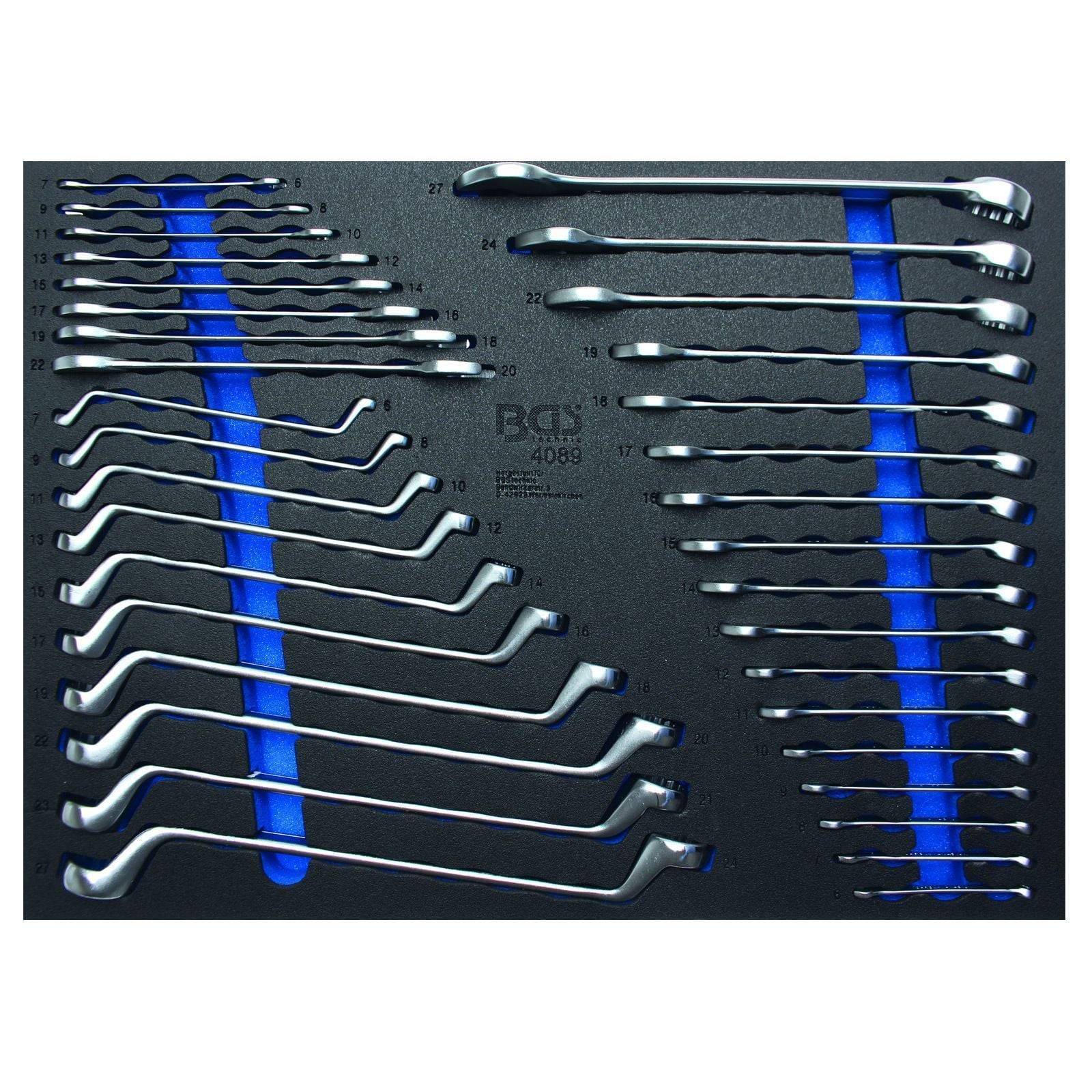 Ein Schaumstoffhalter enthält verschiedene Größen von doppelten Versatz-Ringschlüsseln, nach Größe auf der linken und rechten Seite angeordnet, auf einem schwarzen Hintergrund.