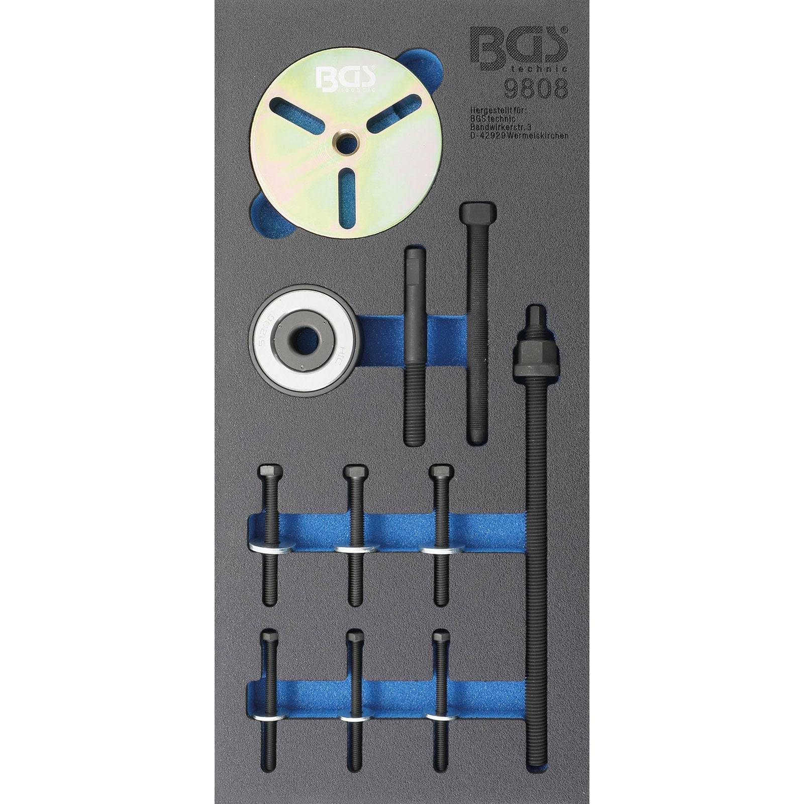 Ein Werkzeugsatz umfasst verschiedene Schrauben, eine Scheibe, ein Lager und Zubehörteile, die in einer Schaumstoffablage organisiert sind.