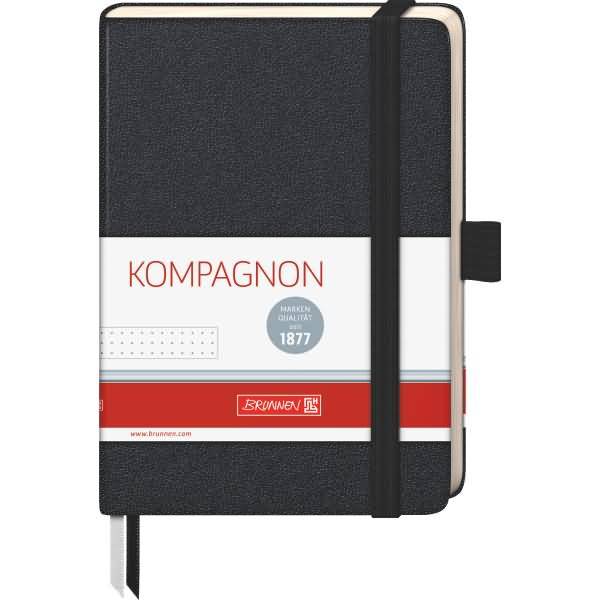 Schwarzes kompaktes Notizbuch mit Gummiband, beschriftet mit „KOMPAGNON