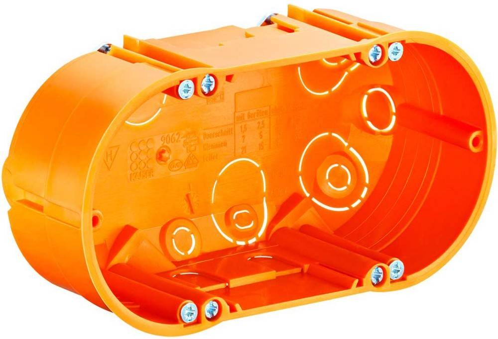 Eine orangefarbene ovale elektrische Anschlussdose mit mehreren Kabeleinführungspunkten und sichtbaren Befestigungsschrauben.