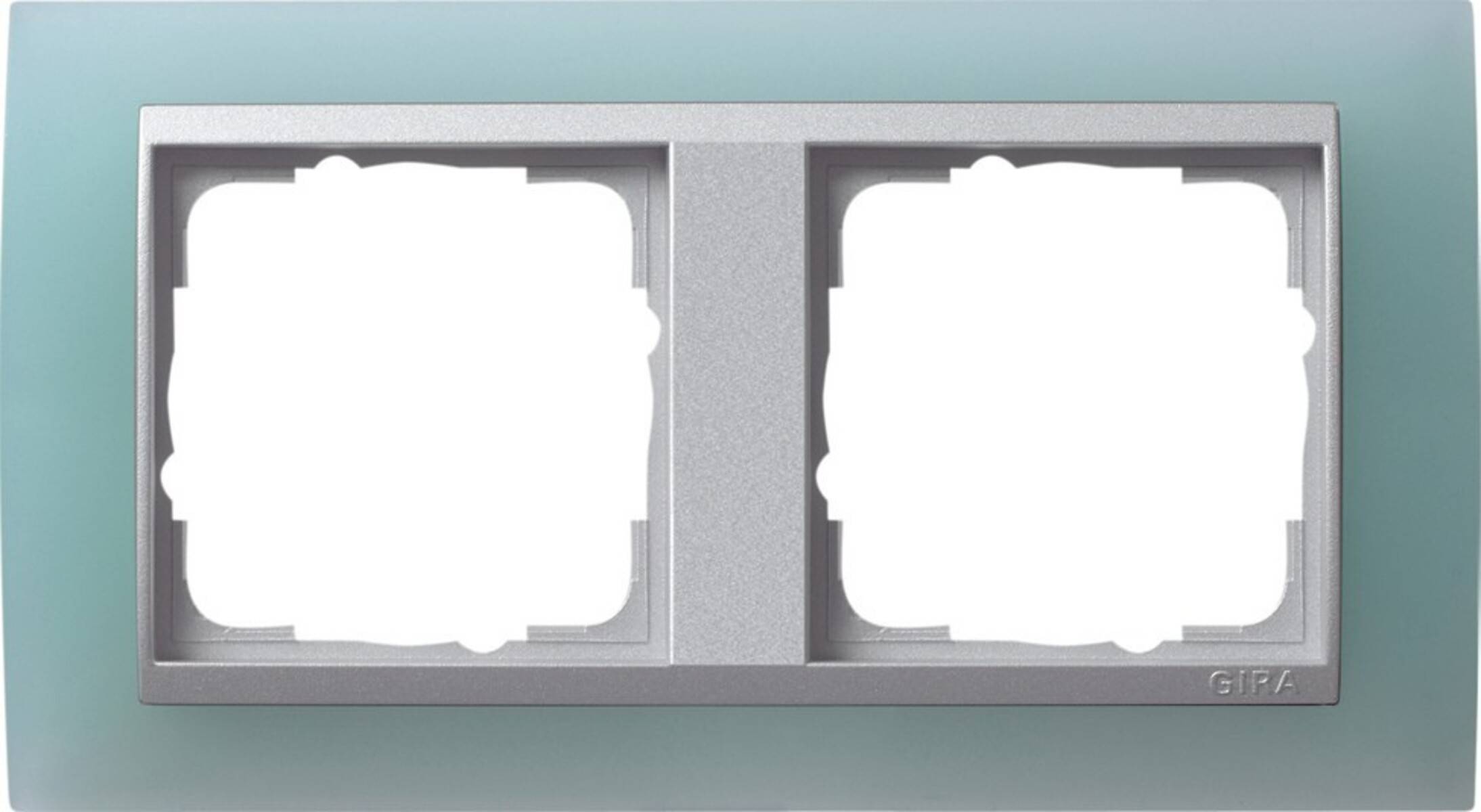 Eine silberne zweiflächige Wandblende mit zwei leeren Schalter- oder Steckdosenöffnungen auf tealblauen Hintergrund.