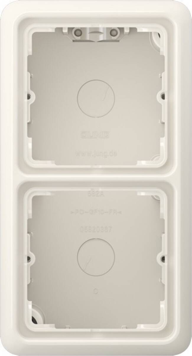 Zwei leere Lichtschalter-Öffnungen auf einer hellgefärbten Wandplatte, mit sichtbaren kreisförmigen Vertiefungen für Schalter und eingraviertem Markennamen.