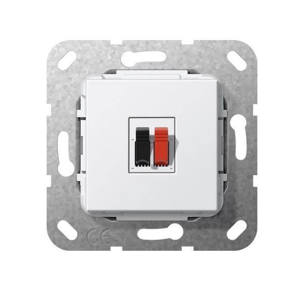 Wandmontierter Lautsprecherterminal mit schwarzen und roten Klemmen für Drahtverbindungen, montiert auf einem Metallhalterahmen.