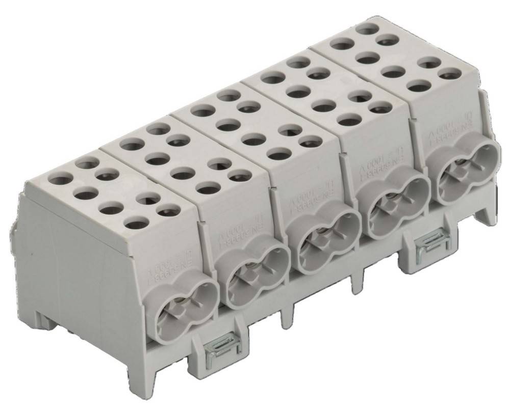 Ein weißer modularer elektrischer Anschlussblock mit mehreren Anschlüssen, der von oben betrachtet für die Verbindung von Kabeln in elektrischen Installationen verwendet wird.