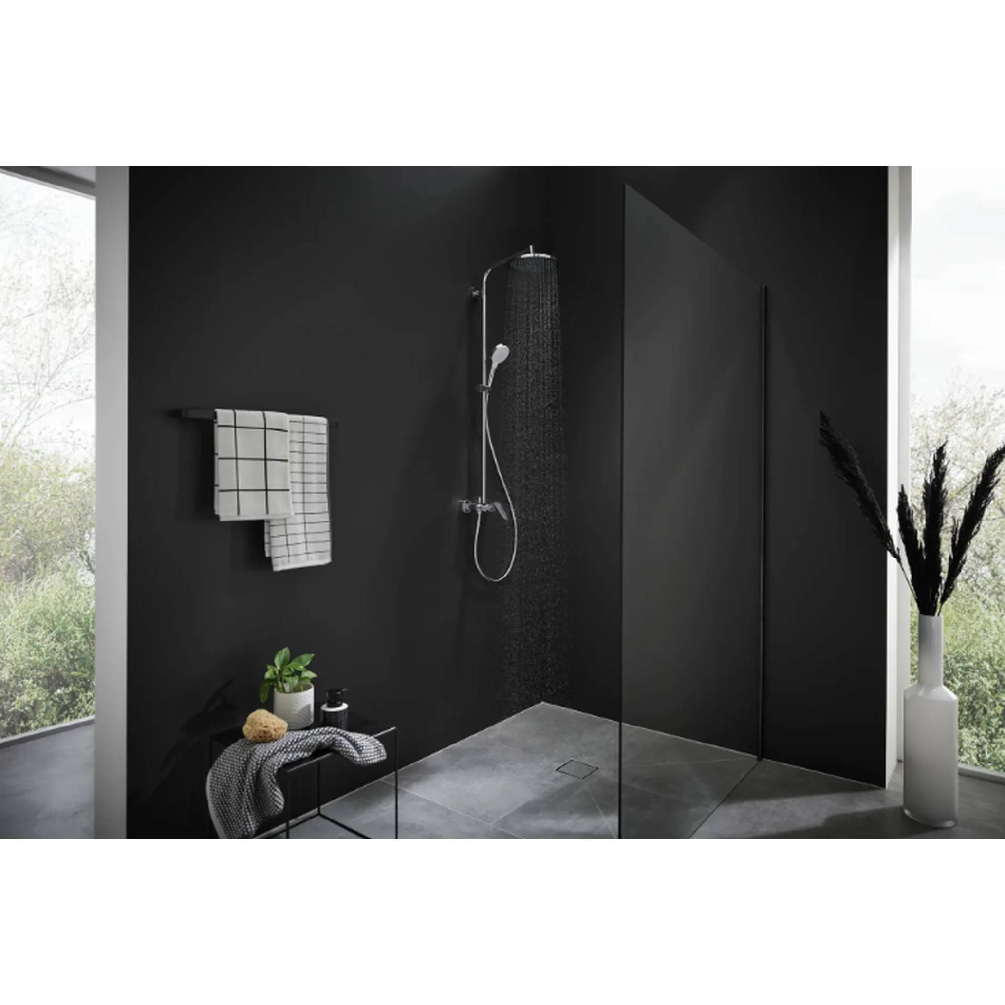 Modernes Badezimmer mit schwarzen Fliesen, Dusche mit wandmontiertem Duschkopf, Handtuchhalter, Bank und Glastrennwand, beleuchtet durch große Fenster.