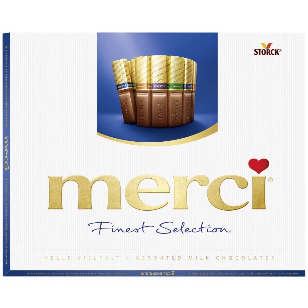 Schachtel Storck merci Finest Selection Praliné-Auswahl aus verschiedenen Milchschokoladen mit goldenen Verpackungen und dem merci Logo auf einer weißen Verpackung.