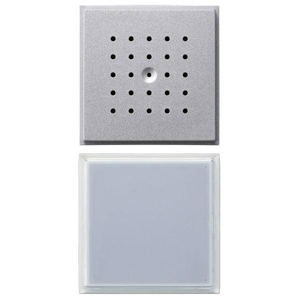 Zwei quadratische Lautsprecher- und Lichtpaneeleinheiten, wobei eine Einheit gelochte Löcher für den Ton und die andere eine mattierte Glasabdeckung für die Beleuchtung aufweist.