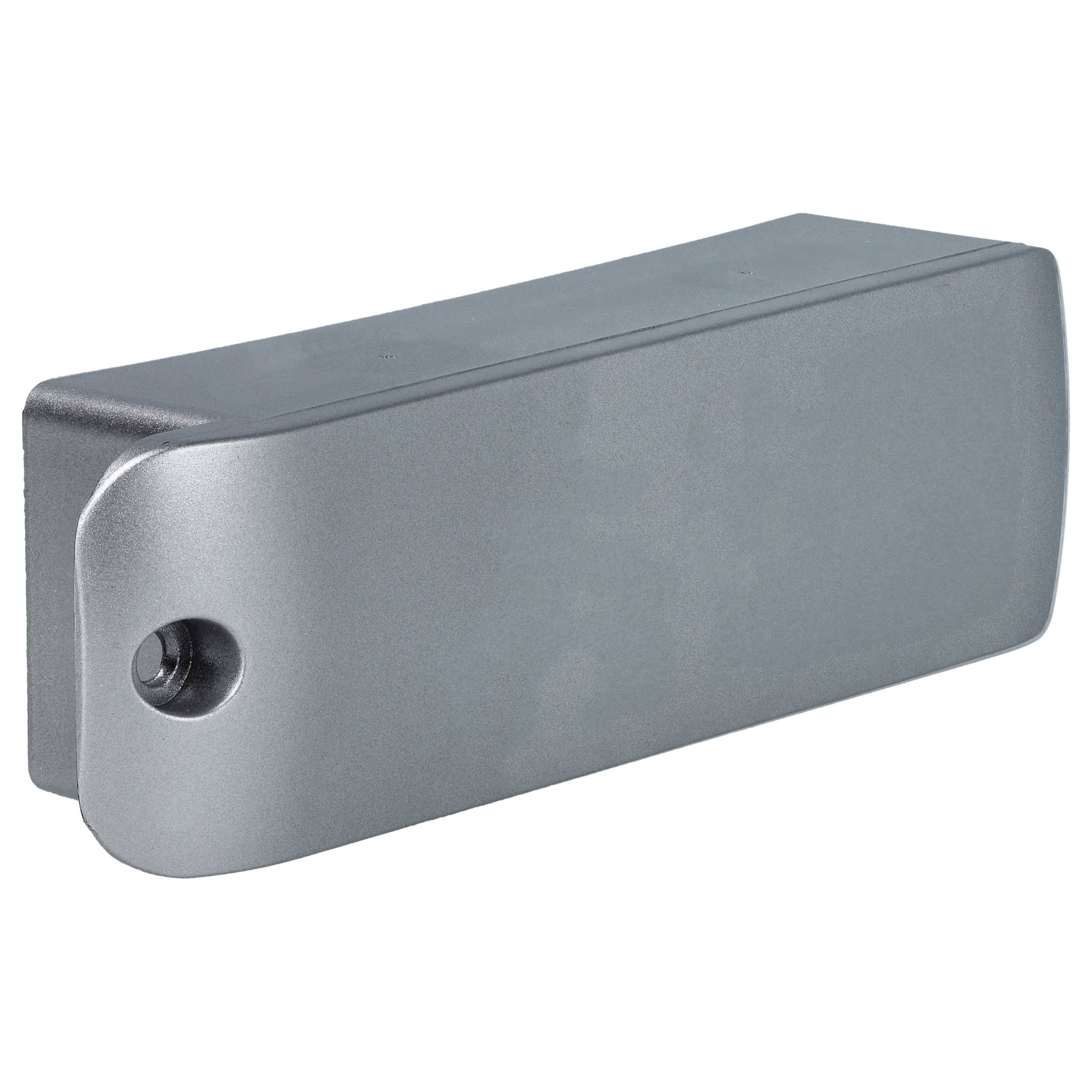 Ein rechteckiges Metall- oder Kunststoffgerät, möglicherweise ein Sensor oder eine Sicherheitskomponente, mit einem kleinen kreisförmigen Loch auf einer Seite.