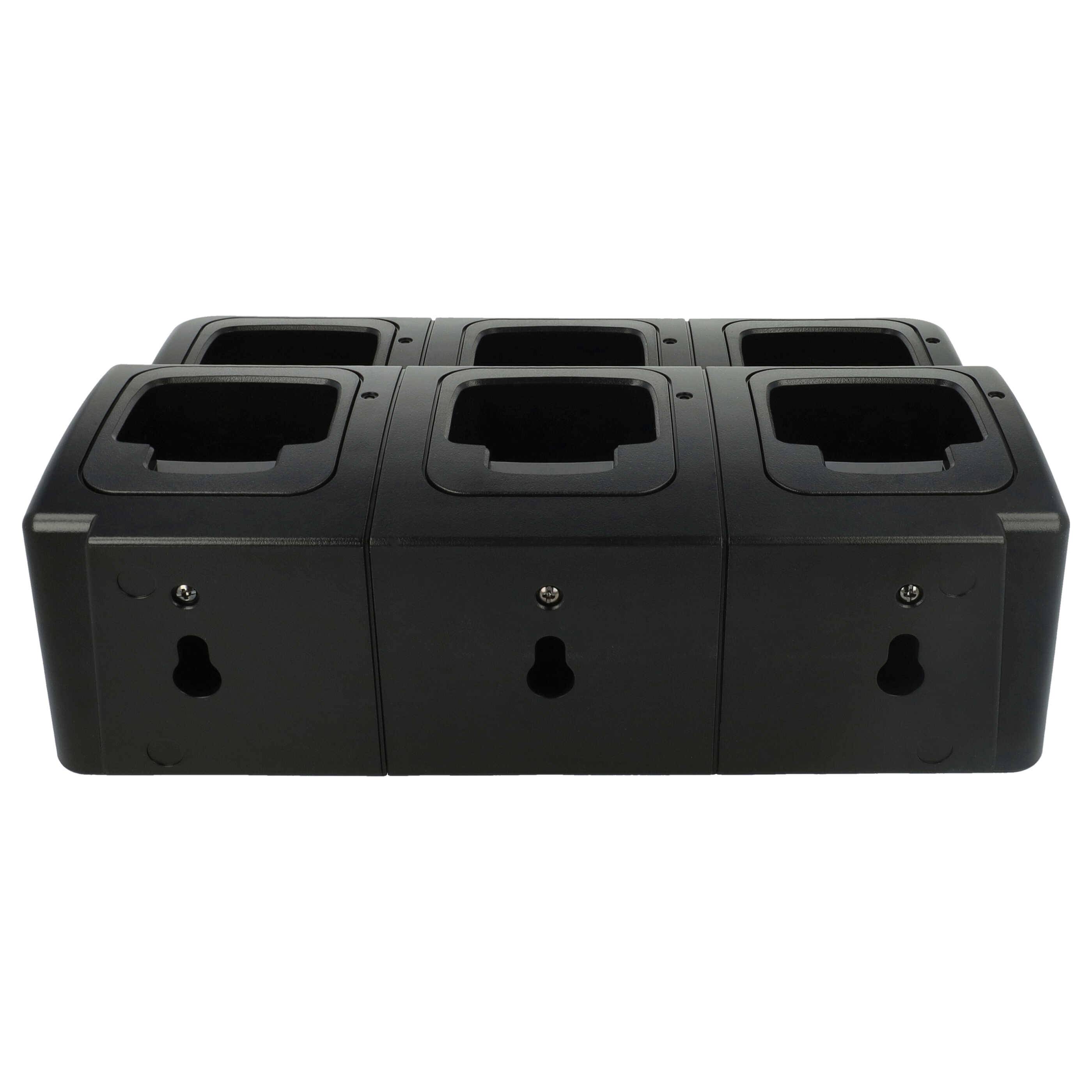 Ein schwarzes Ladedock mit sechs Anschlüssen und Schlüssellochschlitzen auf jedem Abschnitt, entworfen für elektronische Geräte, von vorne gezeigt.