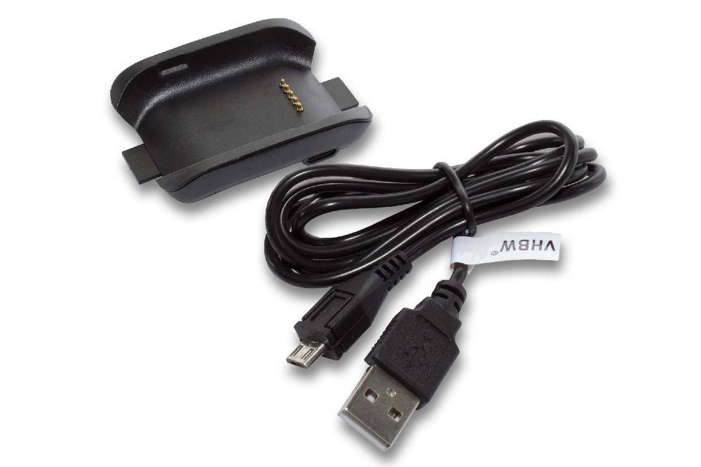Eine schwarze Ladestation mit vergoldeten Kontakten und einem aufgerollten USB-Kabel mit einem Standard-USB- und einem Micro-USB-Stecker wird gezeigt.