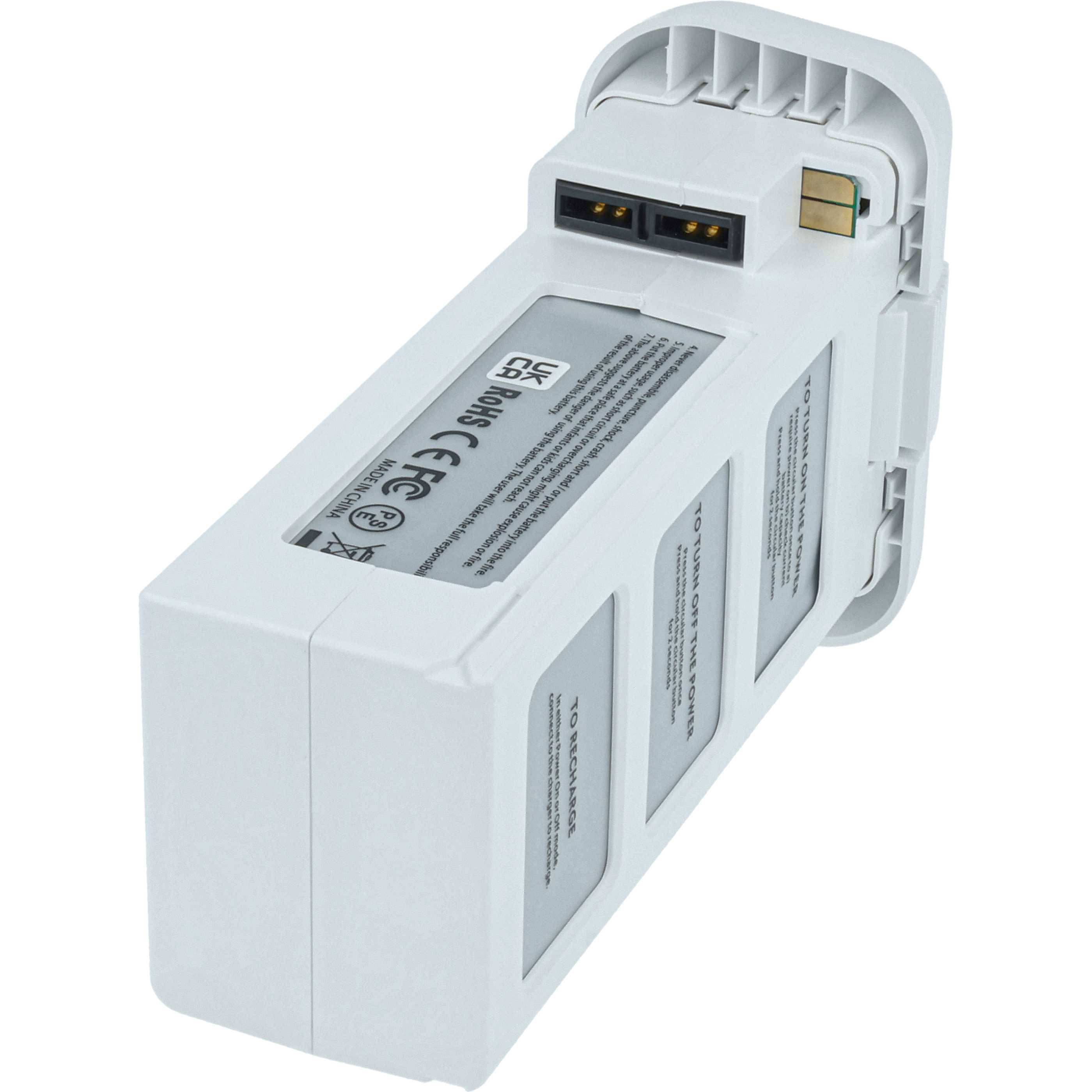 Eine weiße Drohnenakkubatterie mit Steckerstiften und einem Etikett mit Spezifikationen.