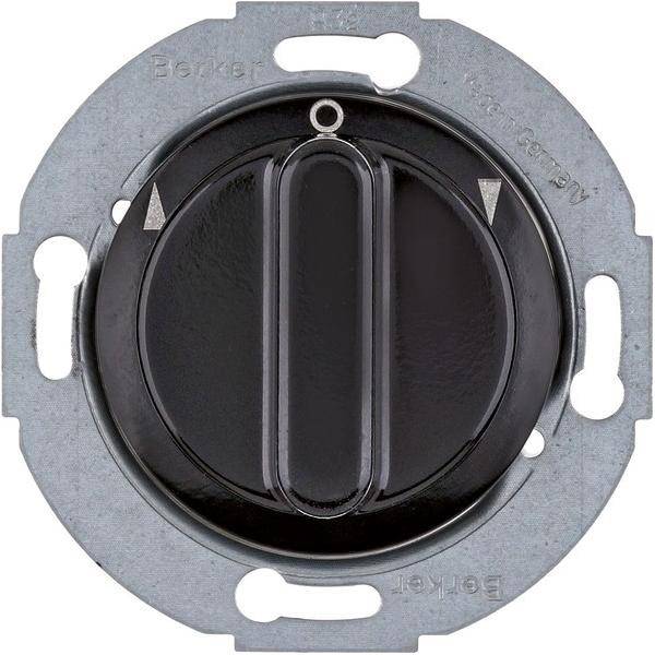 Ein runder, schwarzer Drehdimmer mit einer silbernen Metallmontageplatte, der zwei dreieckige Markierungen an der Oberseite aufweist.