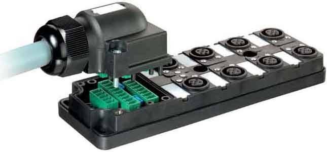 Ein schwarzes und grünes elektronisches Anschlussmodul mit mehreren Anschlüssen und Steckplätzen, ausgestattet mit einer abnehmbaren Abdeckung.