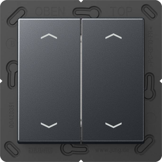 Zwei benachbarte schwarze Wippschalter mit Pfeilen, die nach oben zeigen und die Schaltrichtung andeuten. Der Rahmen hat die Aufschriften 