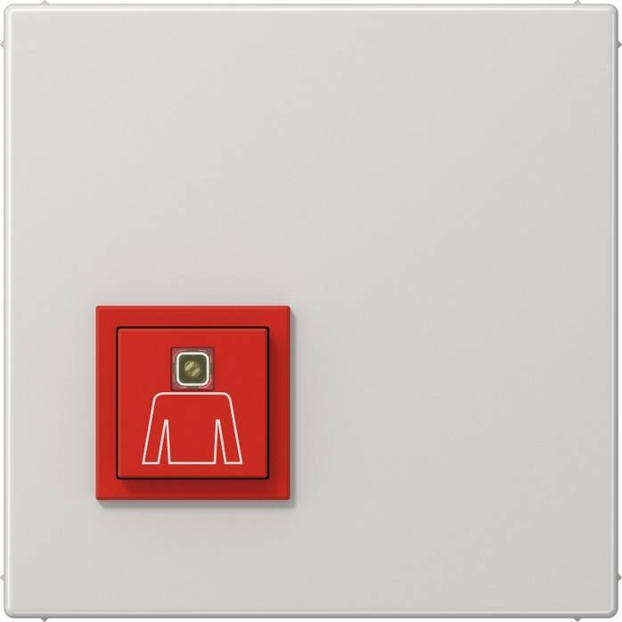 Ein wandmontierter Notfallknopf mit einem roten Quadrat, das eine weiße Ikone eines Hemdes zeigt, möglicherweise ein Notrufpunkt für Hilfe.