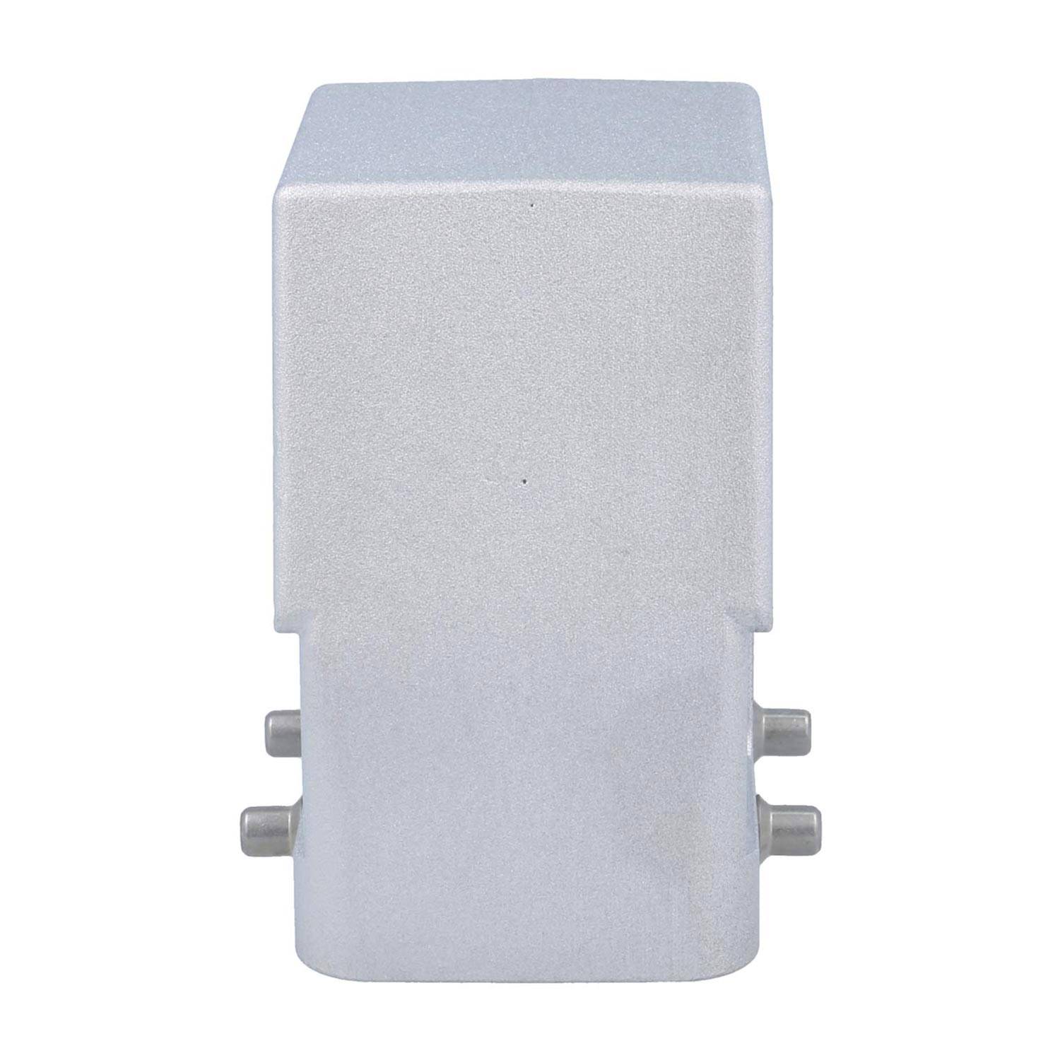 Ein einfaches, silbernes Metallteil mit einer rechteckigen Oberseite und zwei seitlichen Knöpfen, wahrscheinlich eine Komponente eines größeren mechanischen oder elektronischen Geräts.