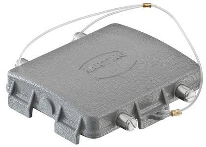 Ein grauer Außengehäuse mit Anschlüssen und Kabeln, markiert mit ‚Magne'; verwendet zur Unterbringung von elektronischen oder telekommunikationstechnischen Geräten.