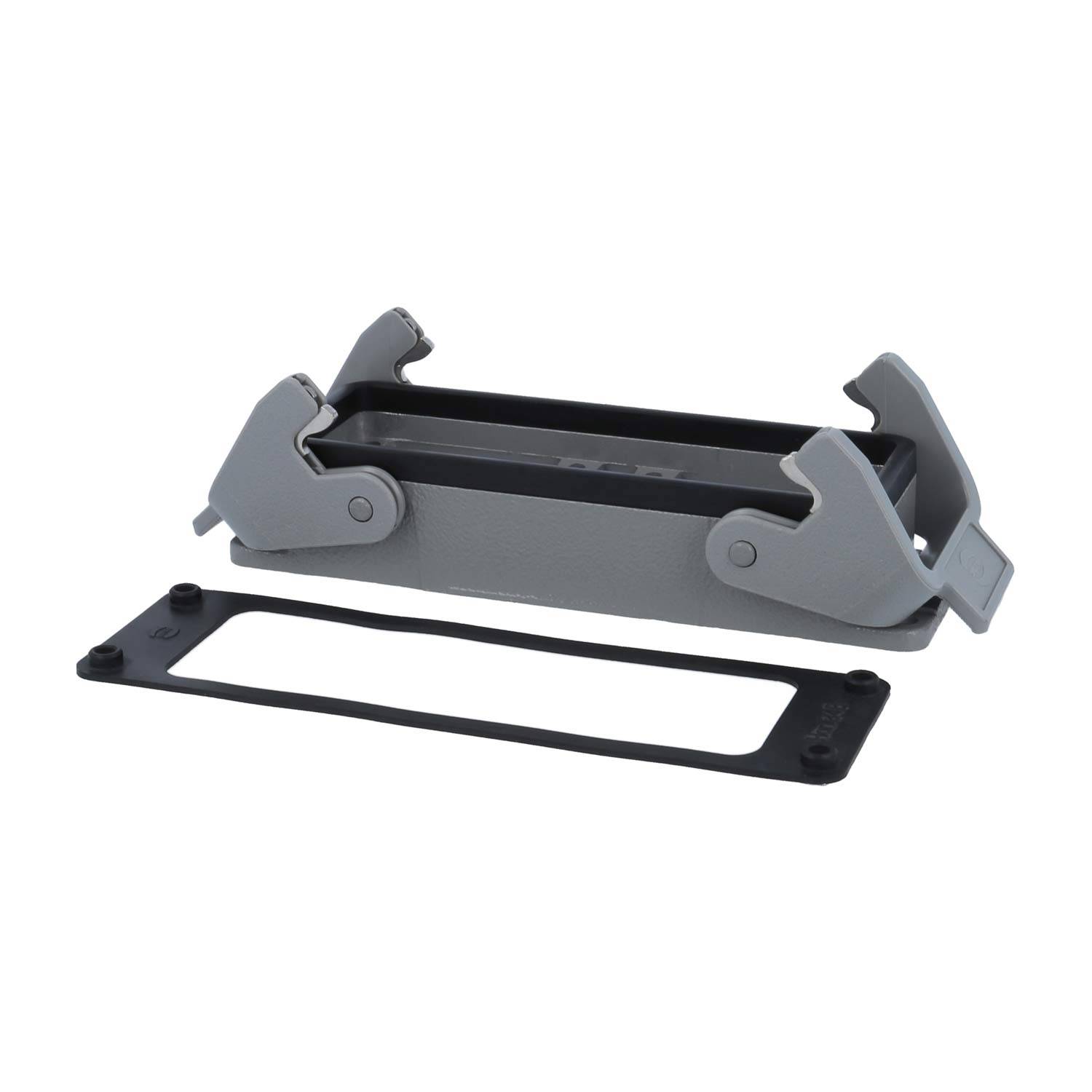 Ein rechteckiges graues Gehäuse für elektrotechnische Steckverbinder mit schwenkbaren Armen und Klemmvorrichtungen, dargestellt neben einer schwarzen Dichtungsleiste, isoliert auf weißem Hintergrund.