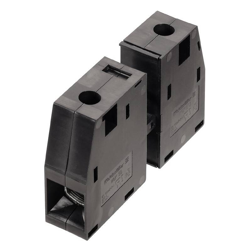 Ein schwarzer Transformator in einem kompakten, rechteckigen Gehäuse mit sichtbaren Anschlusspunkten oben, ausgelegt für elektrische Systeme.