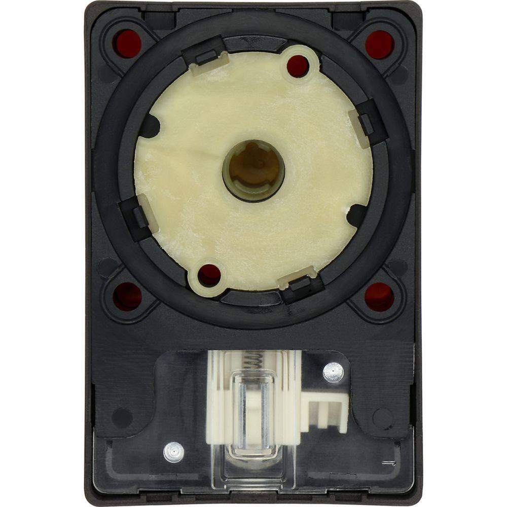 Eine Nahaufnahme eines schwarzen und beigen mechanischen Geräts mit einer kreisförmigen Komponente mit vier roten Löchern und einem durchscheinenden Schalter am unteren Ende.