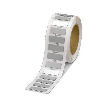 Rolle mit blanken Klebeetiketten auf einer Spule, mit grauen rechteckigen Etikettenbereichen auf weißem Untergrund.