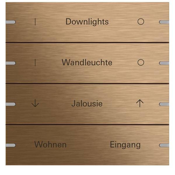 Ein bronzefarbenes Elektropanel mit Tasten, beschriftet mit 'Downlights', 'Wandleuchte', 'Jalousie', 'Wohnen' und 'Eingang', mit Pfeilen versehen.