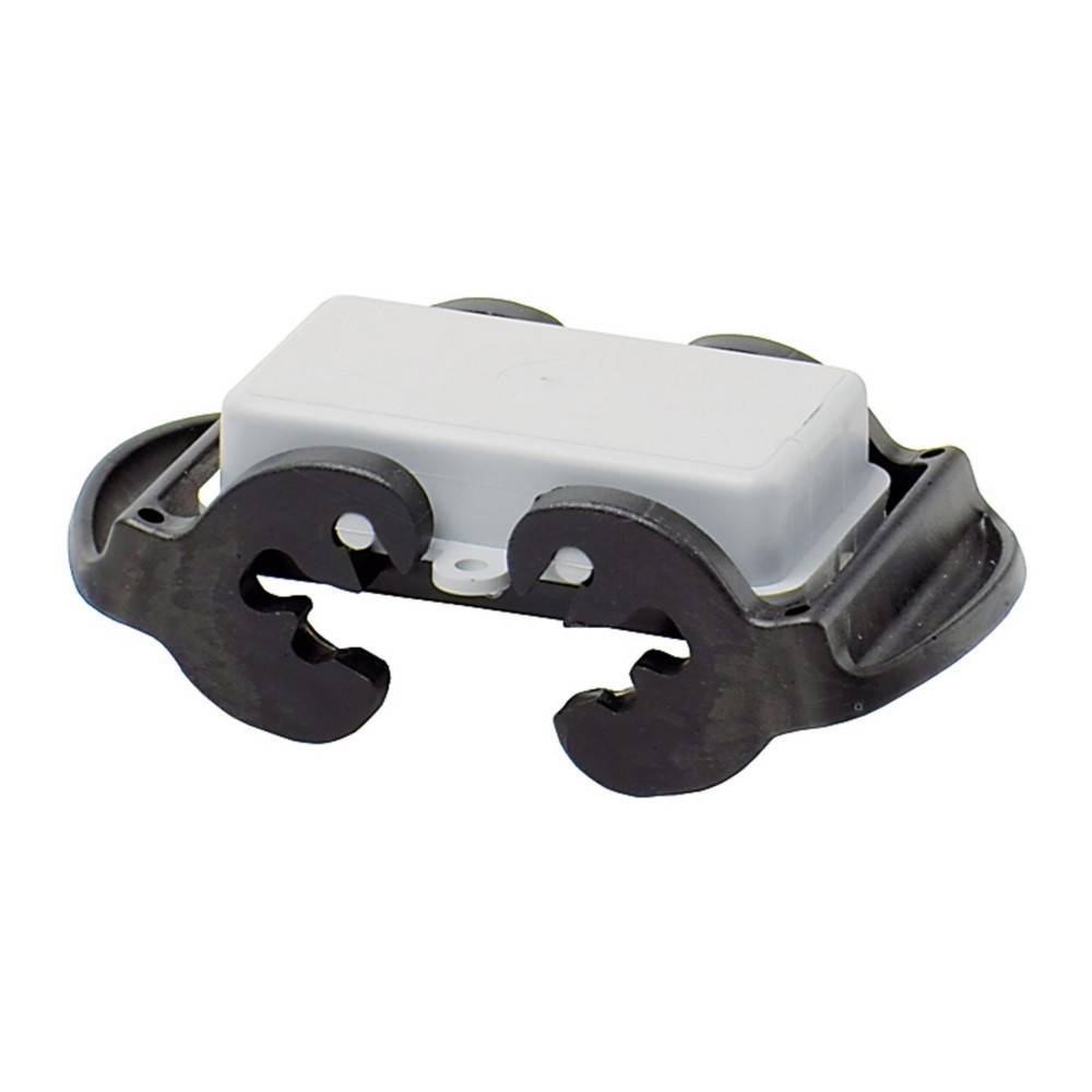 Weißes rechteckiges Objekt auf einer geschwungenen schwarzen Basis mit zwei kreisförmigen Ausschnitten auf jeder Seite, das einen Teil einer mechanischen oder elektronischen Komponente zu ähneln scheint.