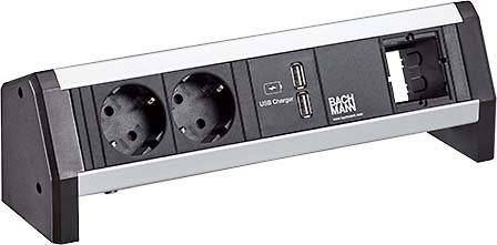 Schwarze Bachmann-Steckdosenleiste mit zwei runden Steckdosen, zwei USB-Ladeanschlüssen und einer Befestigungsklammer für Schreibtisch oder Wand.