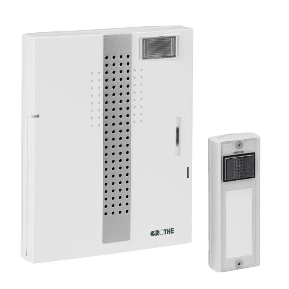 Weißes an der Wand montiertes Sprechanlagesystem mit einem großen Bedienfeld und einer kleineren Türstelle daneben.
