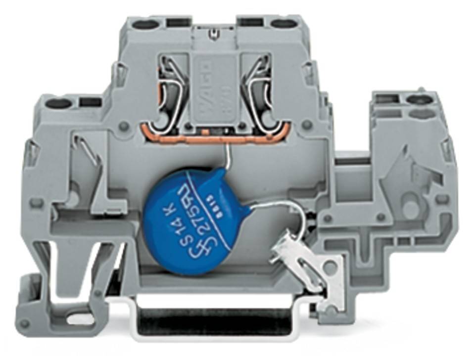 Eine Nahaufnahme eines elektrischen Bauteils mit einem blauen Kondensator, beschriftet mit '275V'. Die Anordnung ist auf einer grauen Kunststoffbasis montiert.