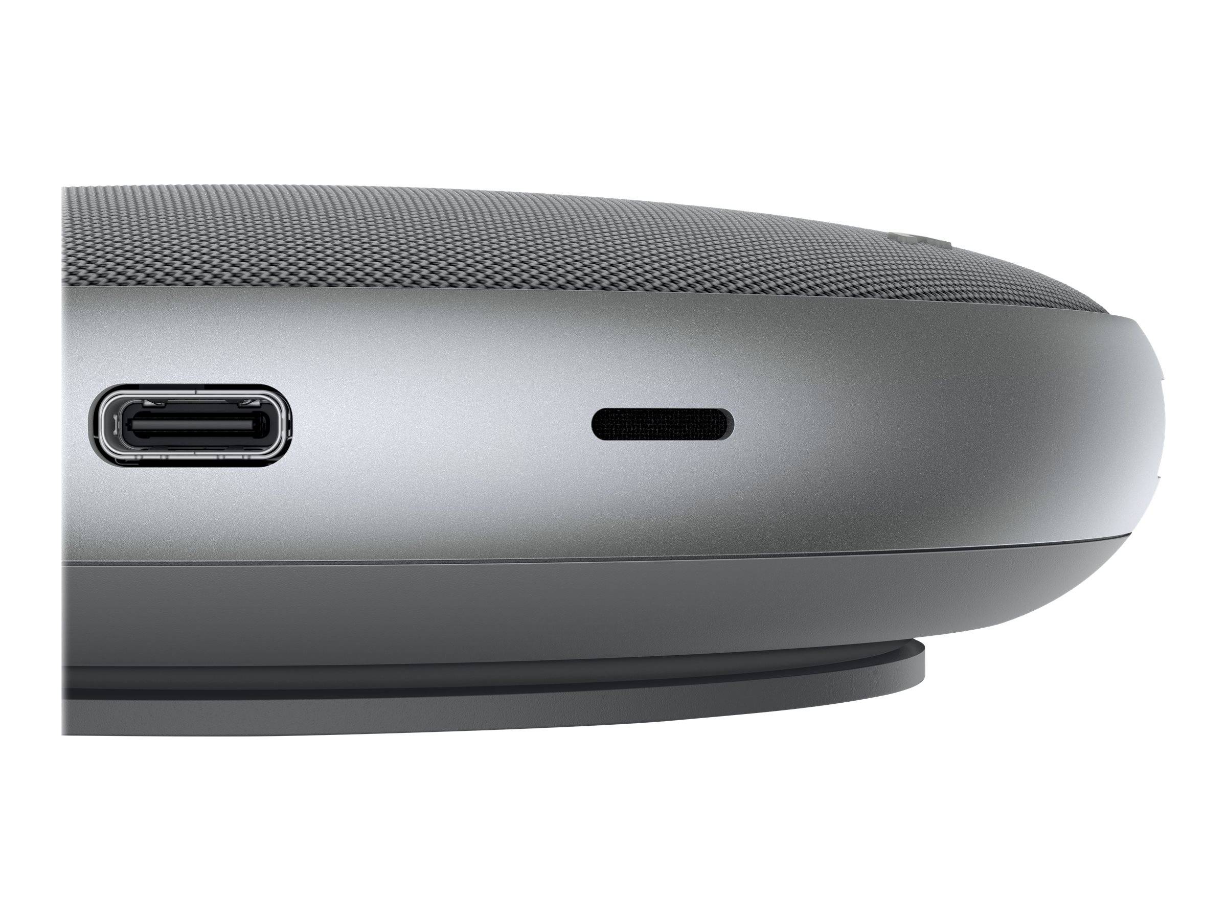 Nahaufnahme einer Seitenansicht eines grauen tragbaren Lautsprechers mit einem USB-C-Ladeanschluss und einem kleinen Statusschlitz.
