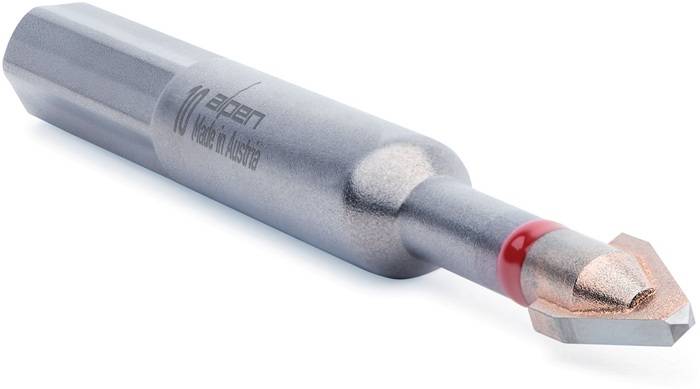 Ein Metalltool, das mit 'Made in Austria' und der Zahl '10' markiert ist. Die Spitze ist sechseckig und deutet darauf hin, dass es sich um einen Bit für einen Schraubendreher handelt.