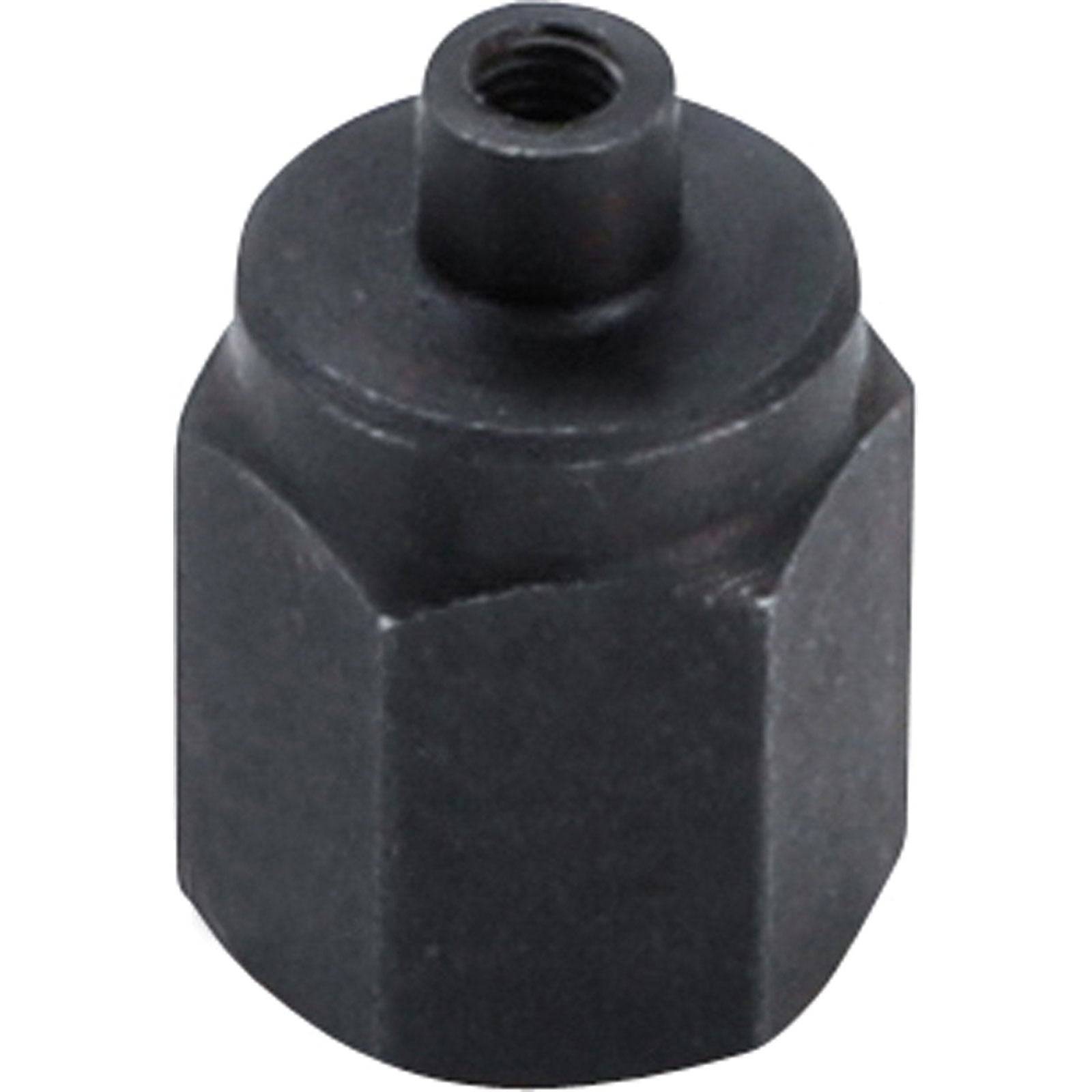 Ein schwarzes, sechseckiges Metallobjekt mit einem Gewindeloch an der Oberseite.