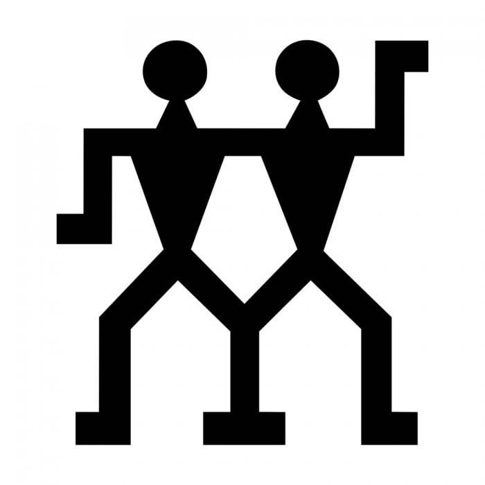 Schwarzes Symbol von zwei stilisierten menschlichen Figuren, die nebeneinander stehen und Arme oder Schultern verbunden haben, was auf Teamwork oder Partnerschaft hindeutet.