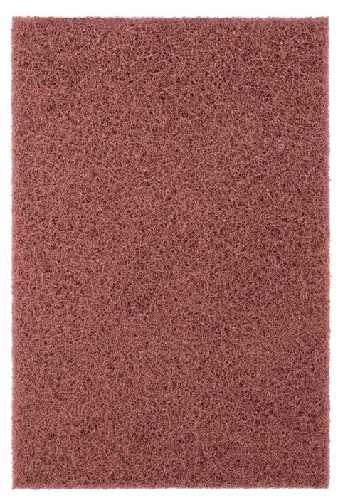 Eine Nahaufnahme eines braunen Scheuerschwamms mit grober, faseriger Textur.