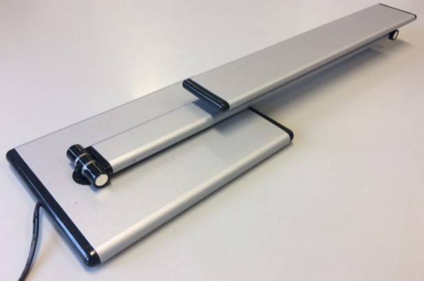 Zwei silberfarbene klappbare Laptop-Ständer übereinander auf einer weißen Oberfläche gestapelt, die ihr schlankes verstellbares Design zeigen.