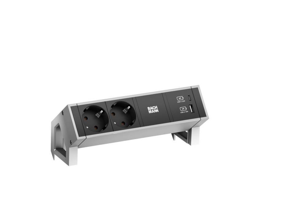 Steckdosenleiste mit zwei Steckdosen, zwei USB-Anschlüssen und einem Markenlabel von 'BACHMANN'. Entwickelt zum Anschluss mehrerer Geräte.