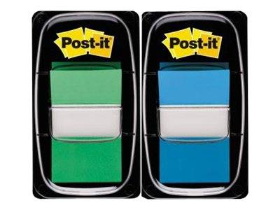 Zwei Post-it-Notizblöcke in schwarzen Kunststoffhaltern, einer grün und einer blau, nebeneinander auf weißem Hintergrund gezeigt.