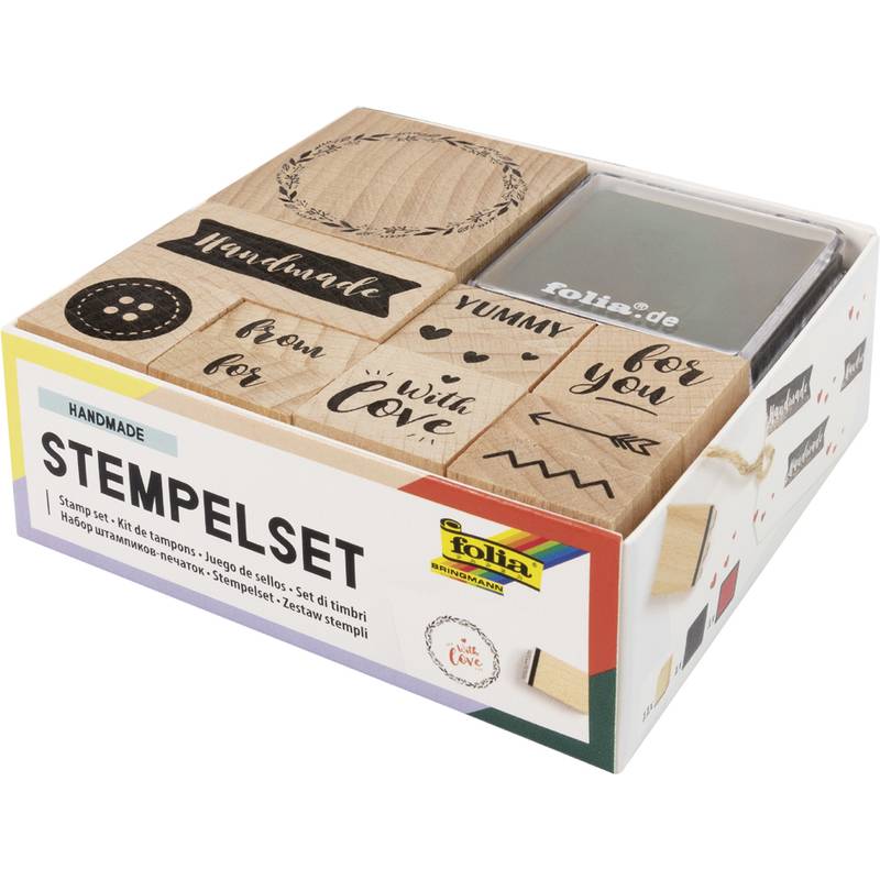 Verpacktes handgefertigtes Stempelset mit Holzstempeln, die dekorative Wörter, Herzen, Kränze und Mustermotive zeigen
