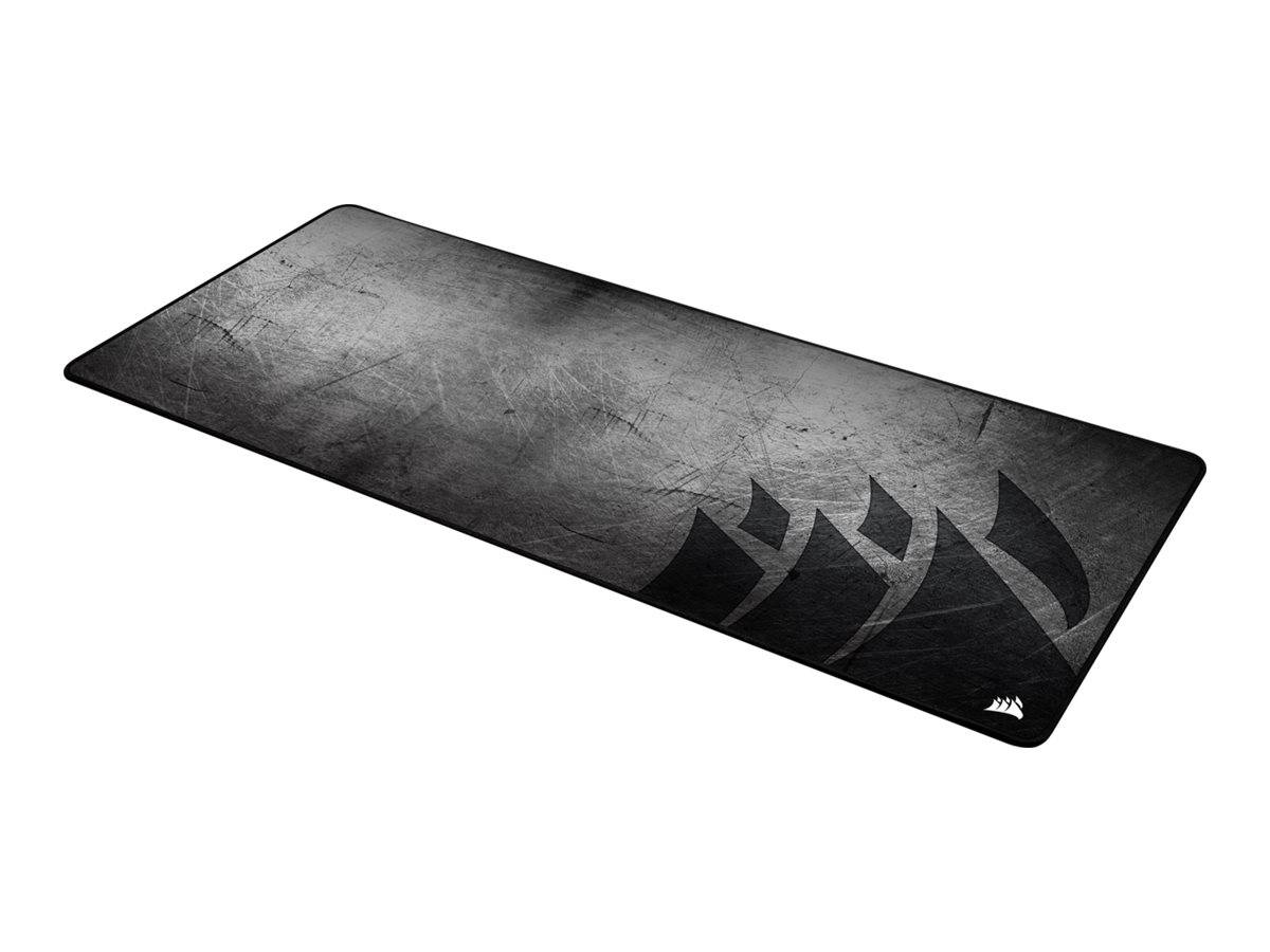 Schwarzes rechteckiges Gaming-Mousepad mit abgenutzter strukturierter Oberfläche und dunkler abstrakter Eckengrafik.