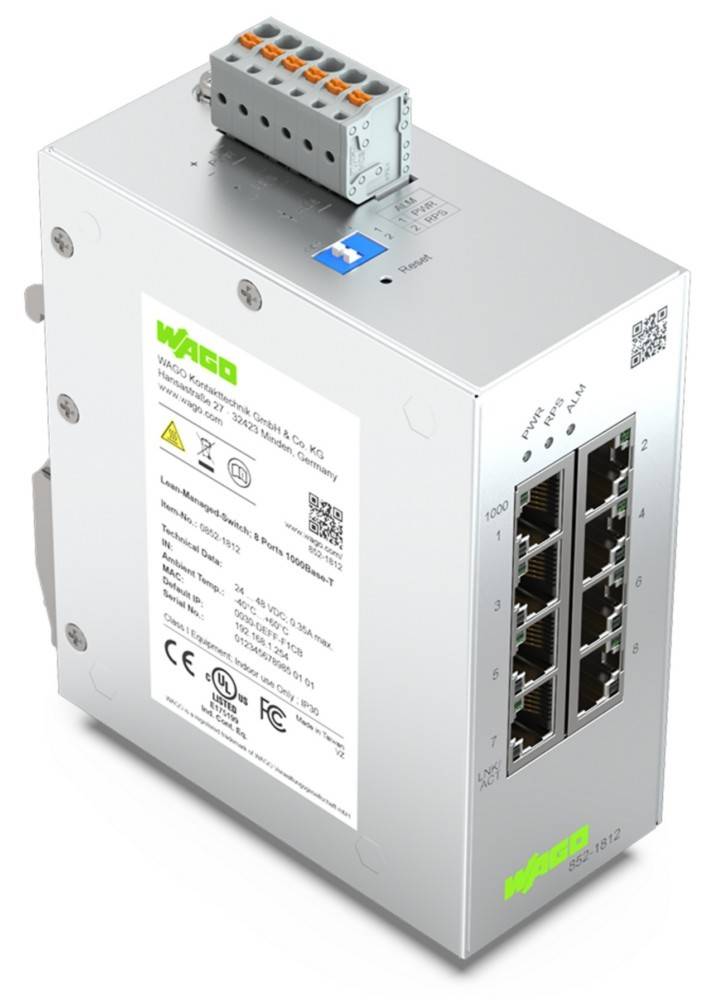 Ein silberner Netzwerk-Switch mit acht Ethernet-Ports, einem grünen Etikett mit der Aufschrift 