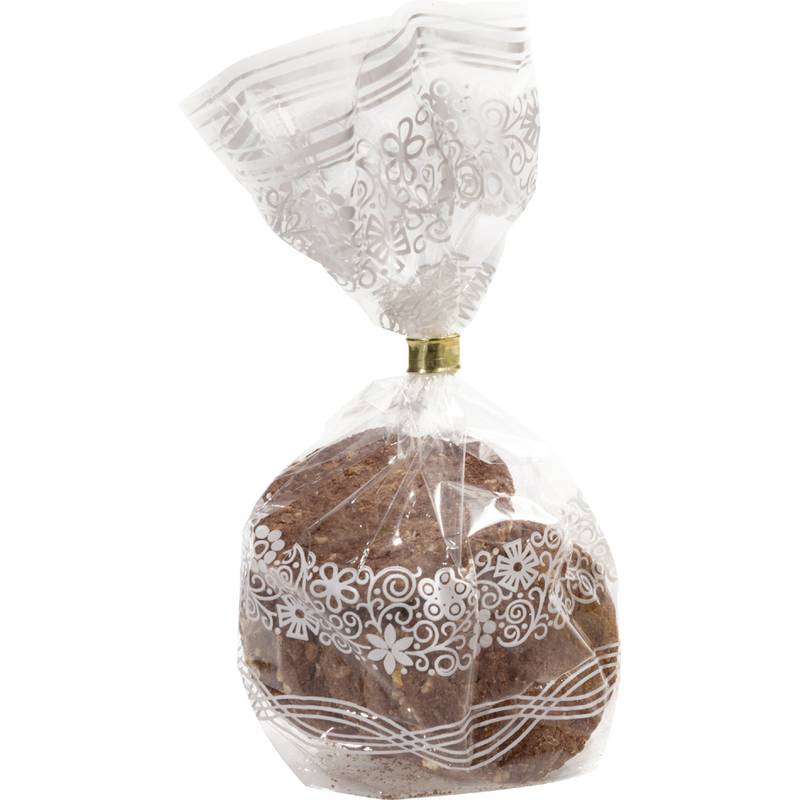Eingewickelter Laib oder Kuchen in einer durchsichtigen Plastiktüte mit weißem Blumenmuster und verdrehtem Verschluss.