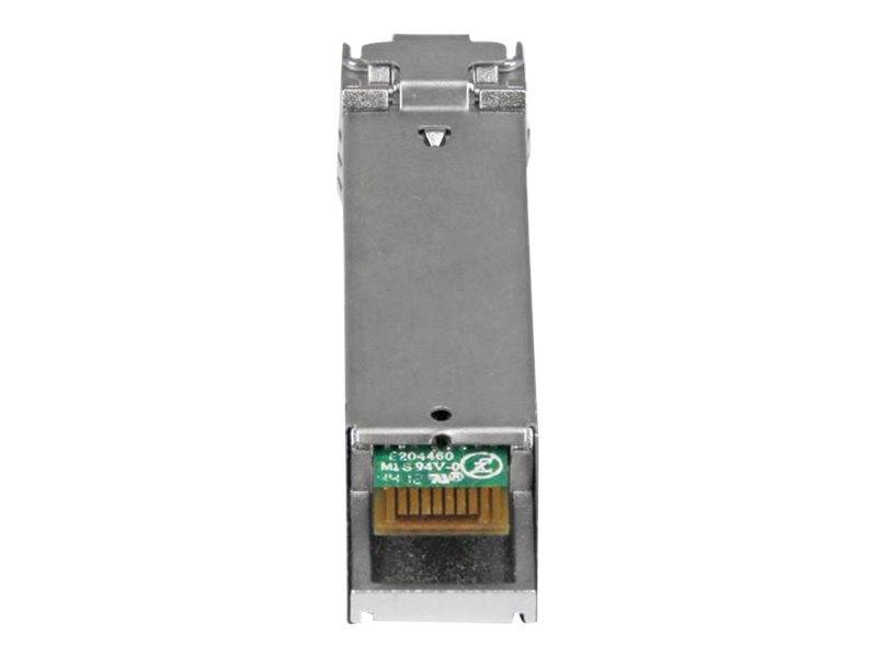 Nahaufnahme eines metallenen Netzwerk-Transceiver-Moduls mit einem kleinen grünen Schaltungsetikett und vergoldeten Steckkontakten, isoliert auf weißem Hintergrund.