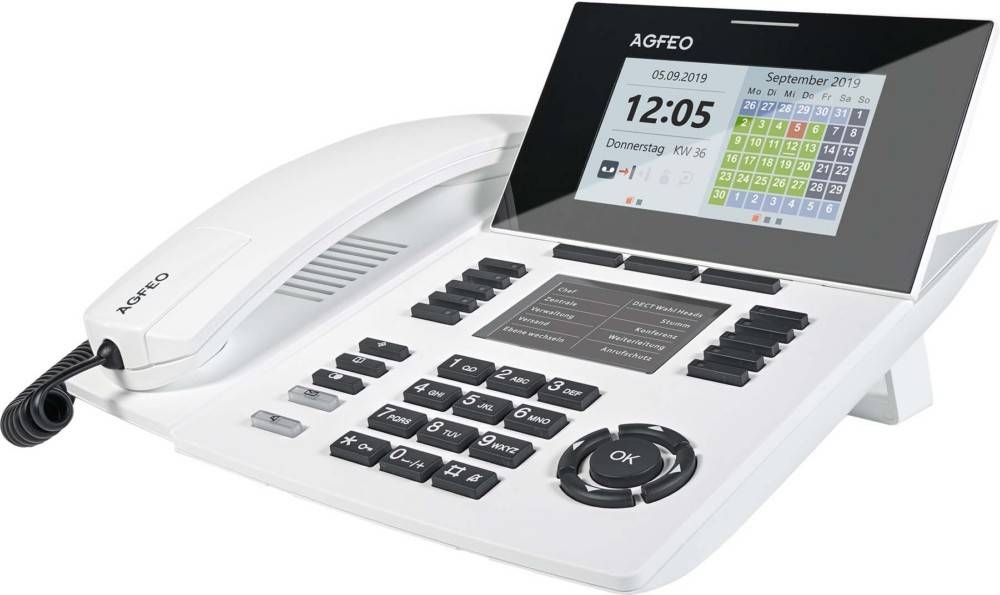 Weißes Büro-Telefon mit digitalem Display, auf dem das Datum '05.09.2019' und ein Wochenkalender angezeigt werden. Numerische und Funktionstasten sind sichtbar.