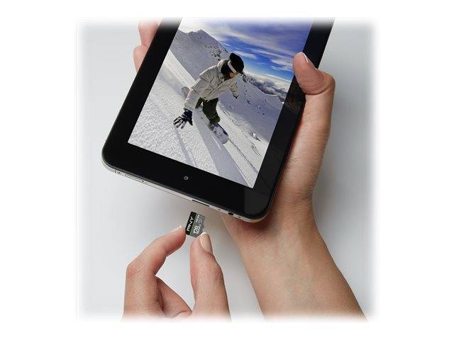 Hände führen eine Speicherkarte in ein Tablet ein, auf dem ein Snowboarder auf einem schneebedeckten Berghang angezeigt wird.